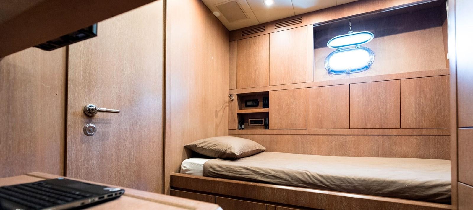 a room with a bed and a window aboard BLOOMS Yacht for Charter