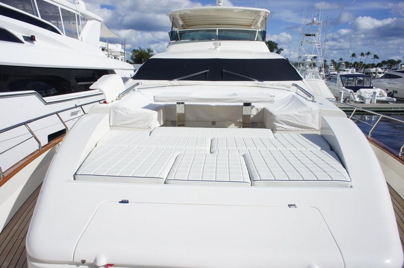 a white yacht in a harbor with Ice hockey rink in the background aboard CASPIAN Yacht for Sale