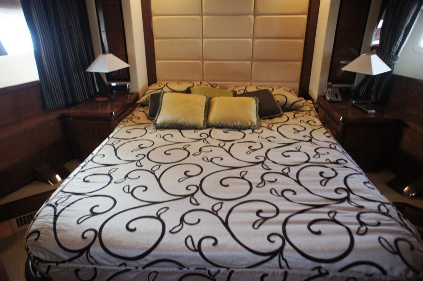 a bed with a black and white comforter and pillows aboard CASPIAN Yacht for Sale