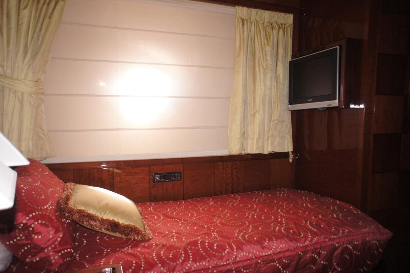 a room with a bed and a television aboard CASPIAN Yacht for Sale