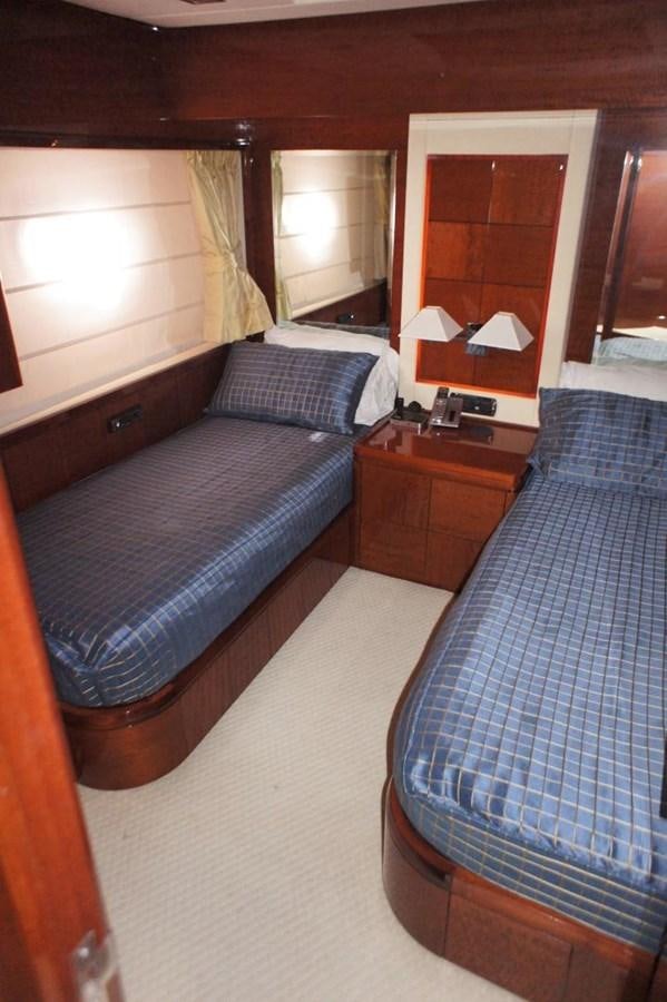 a bed with a blue bedspread and a mirror aboard CASPIAN Yacht for Sale