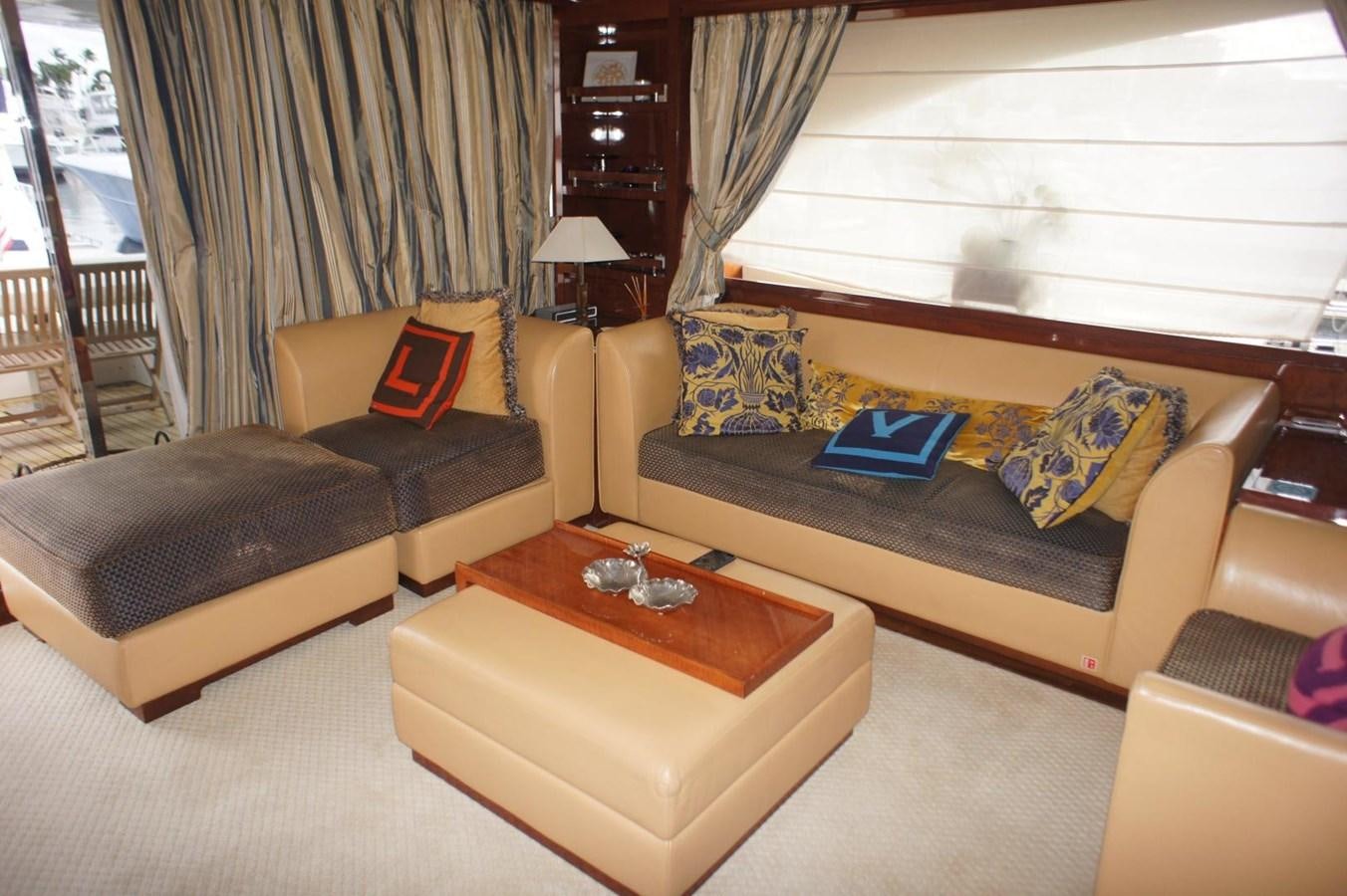 a living room with leather couches and a coffee table aboard CASPIAN Yacht for Sale