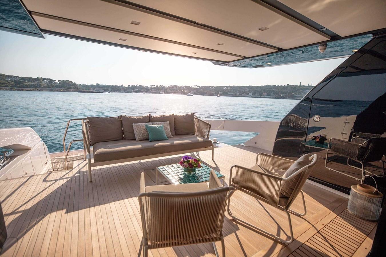 a deck with a couch and a table and chairs on it aboard 2019 SANLORENZO SX76 #16 Yacht for Sale