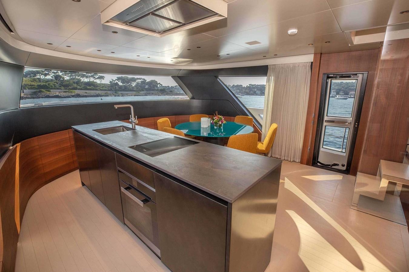 a kitchen with a table and chairs aboard 2019 SANLORENZO SX76 #16 Yacht for Sale