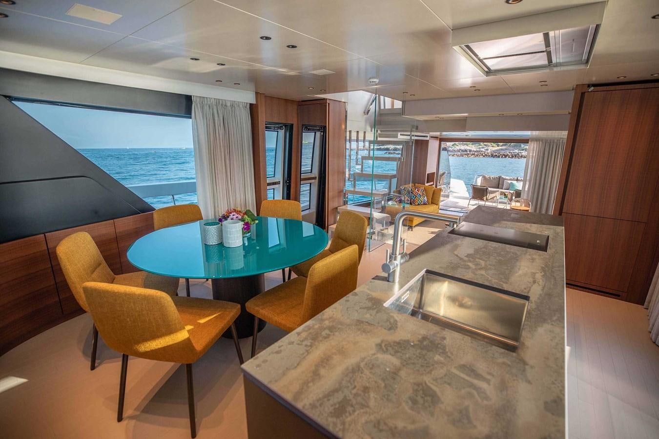 a room with a table and chairs aboard 2019 SANLORENZO SX76 #16 Yacht for Sale