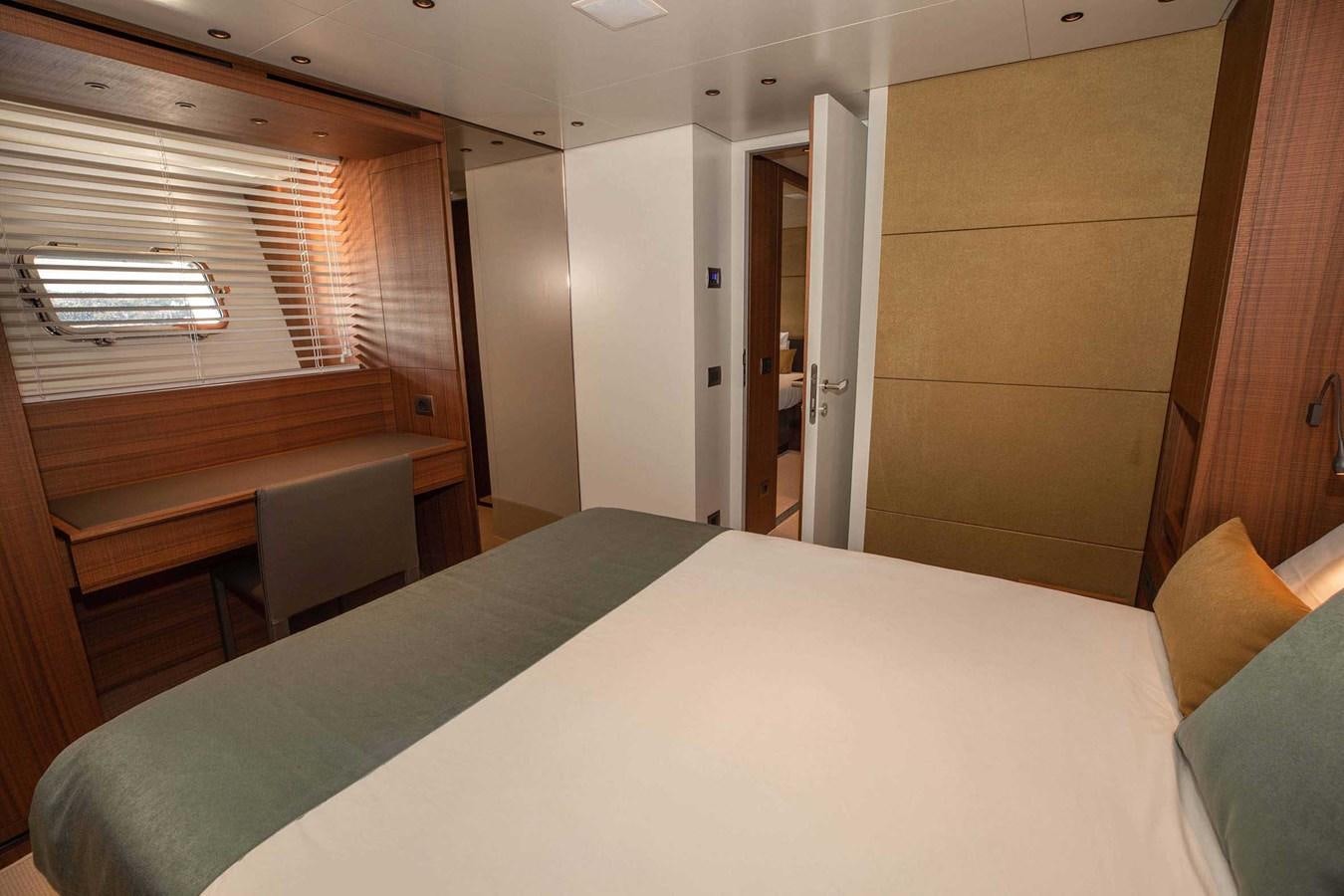 a room with a bed and a window aboard 2019 SANLORENZO SX76 #16 Yacht for Sale
