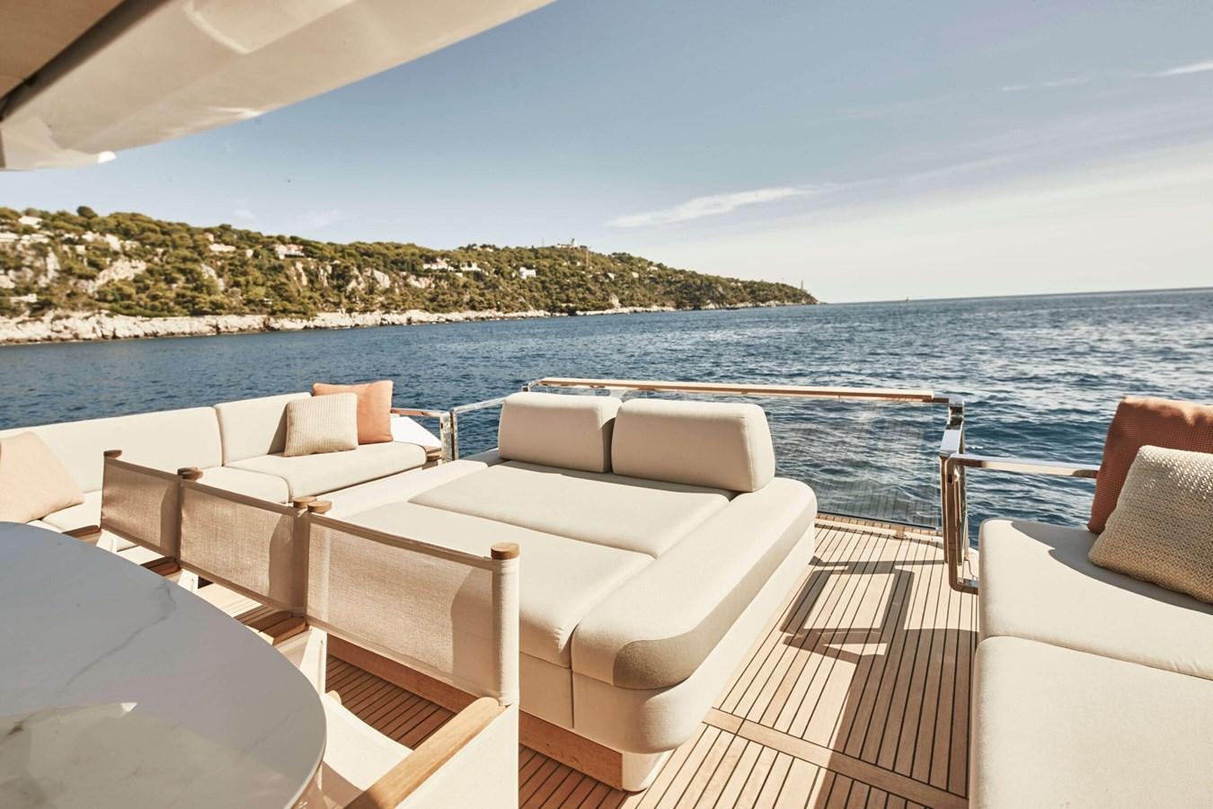 a deck with chairs and a body of water in the background aboard 2022 PRESTIGE X70 #09 Yacht for Sale