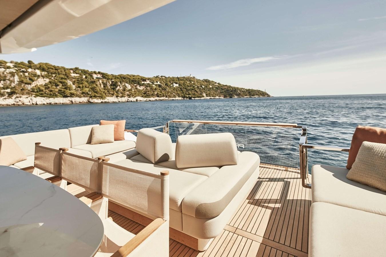 a deck with chairs and a body of water in the background aboard 2022 PRESTIGE X70 #09 Yacht for Sale
