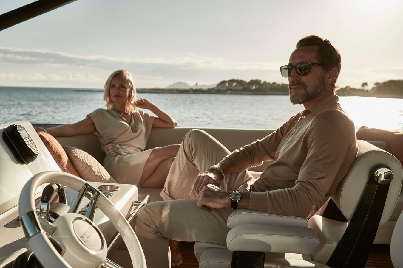 a group of people sitting on a boat aboard 2022 PRESTIGE X70 #09 Yacht for Sale