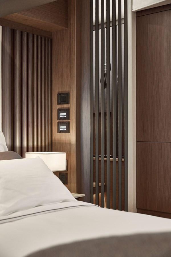 a bed next to a door aboard 2022 PRESTIGE X70 #09 Yacht for Sale