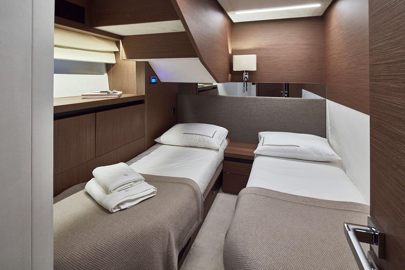 a room with beds and a lamp aboard 2022 PRESTIGE X70 #09 Yacht for Sale