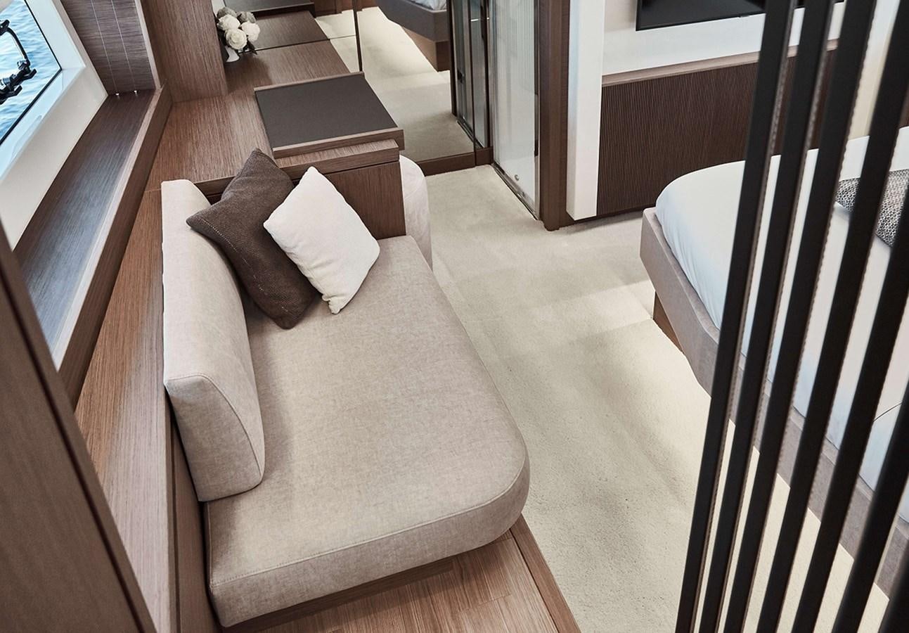 a room with a couch and a rug aboard 2022 PRESTIGE X70 #09 Yacht for Sale