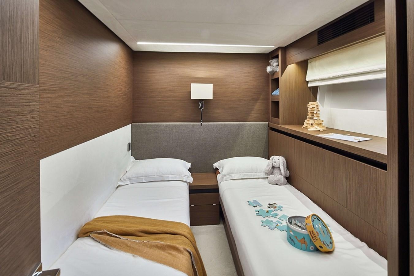 a room with a bed and a table aboard 2022 PRESTIGE X70 #09 Yacht for Sale