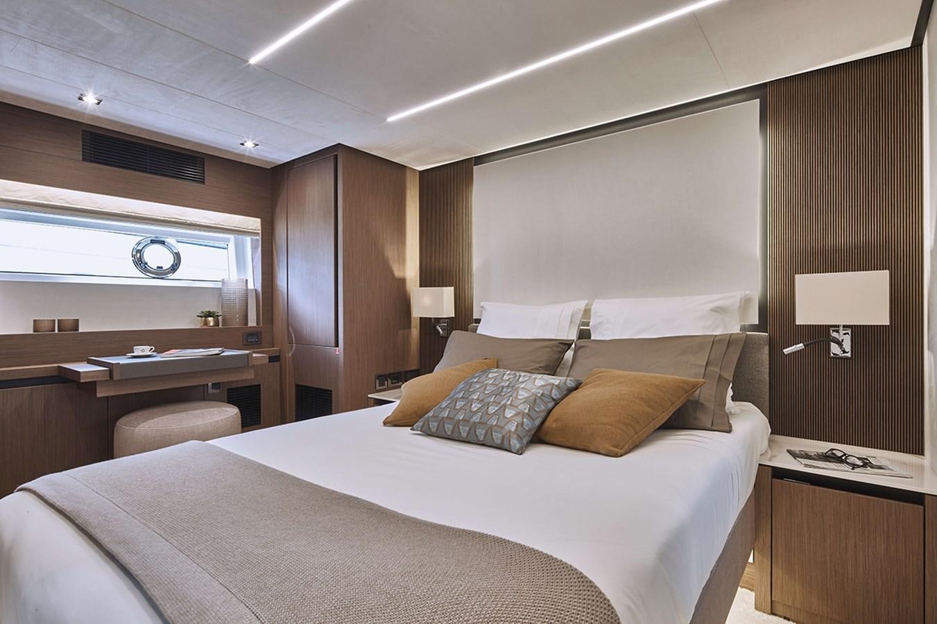 a bed with a white comforter aboard 2022 PRESTIGE X70 #09 Yacht for Sale