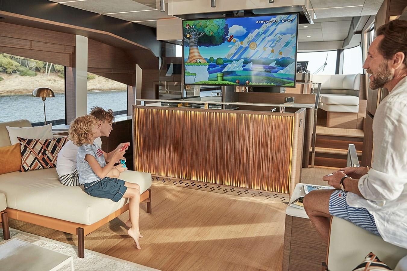 a man and a woman watching television aboard 2022 PRESTIGE X70 #09 Yacht for Sale