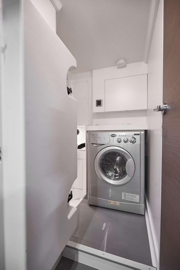a washer and dryer in a kitchen aboard 2022 PRESTIGE X70 #09 Yacht for Sale