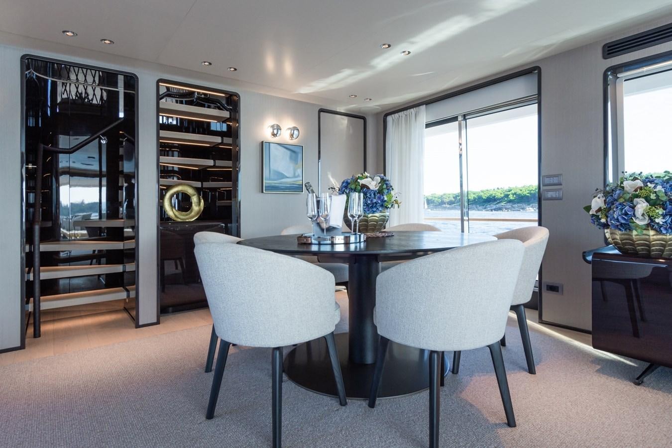 a large kitchen with a table and chairs aboard MRS L Yacht for Sale