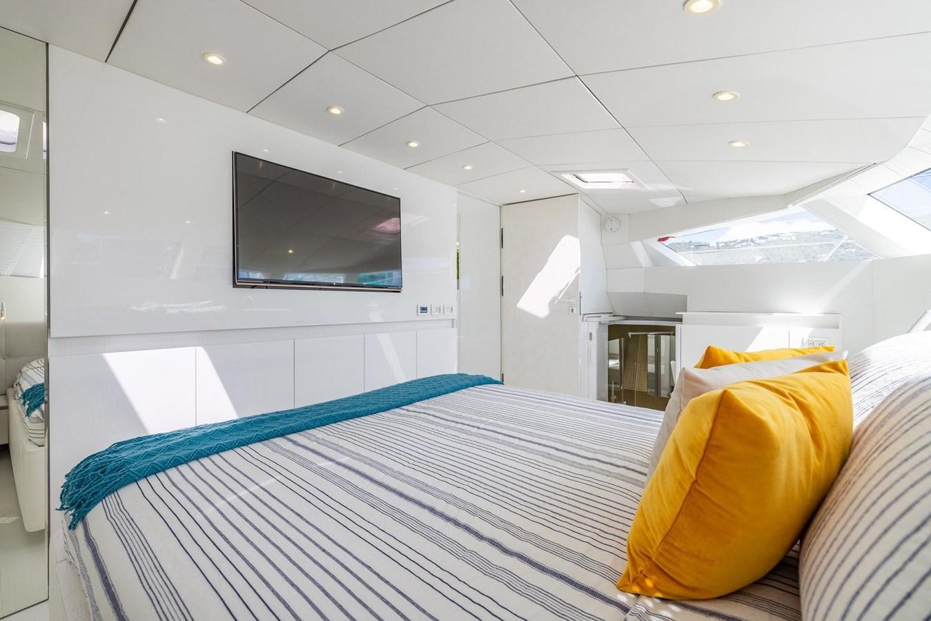 a room with a bed and a tv on the wall aboard VALHALLA Yacht for Sale