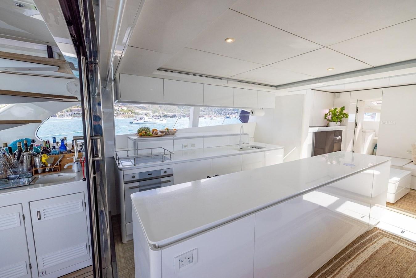 a kitchen with white cabinets aboard VALHALLA Yacht for Sale
