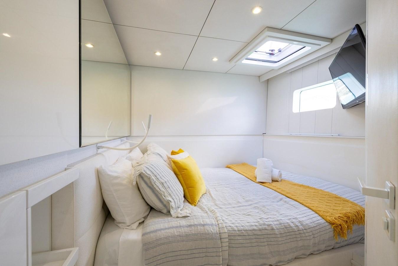 a bed with yellow pillows aboard VALHALLA Yacht for Sale