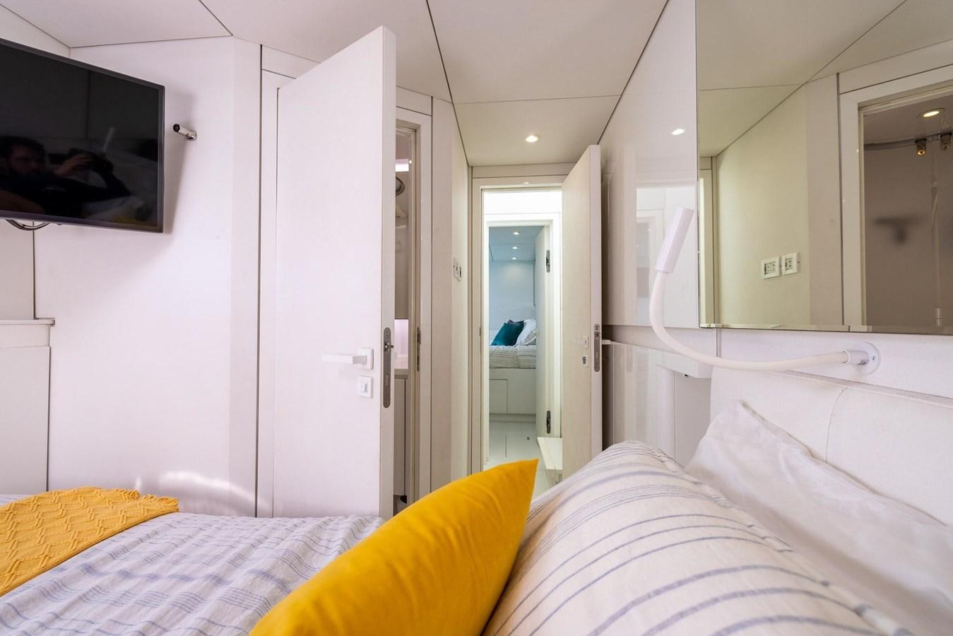 a bedroom with a bed and a television on the wall aboard VALHALLA Yacht for Sale