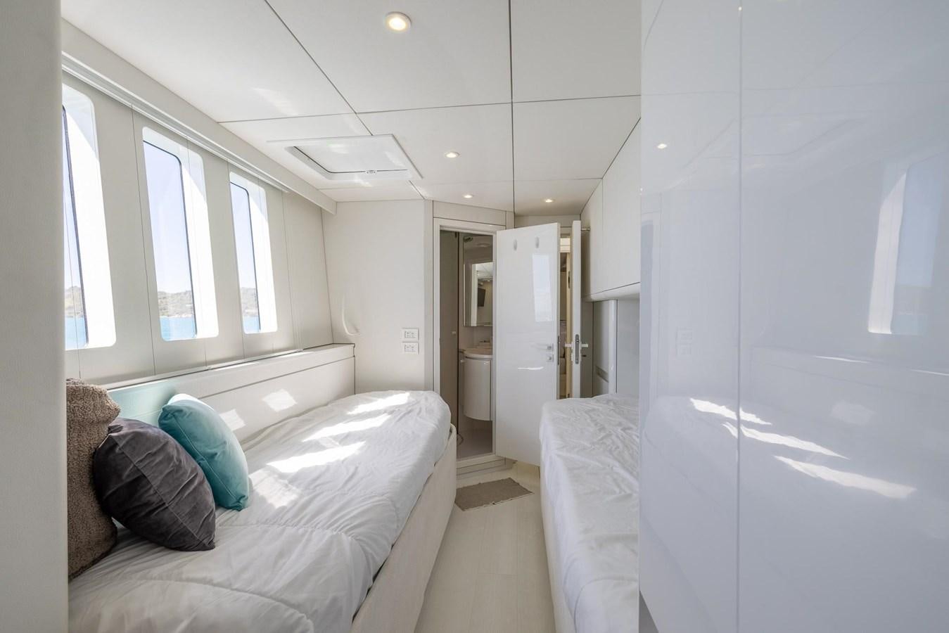 a bedroom with a bed and a window aboard VALHALLA Yacht for Sale