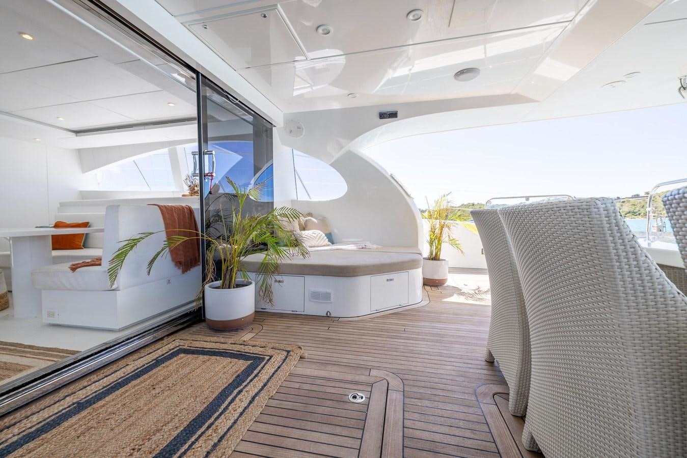 a room with a couch and a plant in it aboard VALHALLA Yacht for Sale