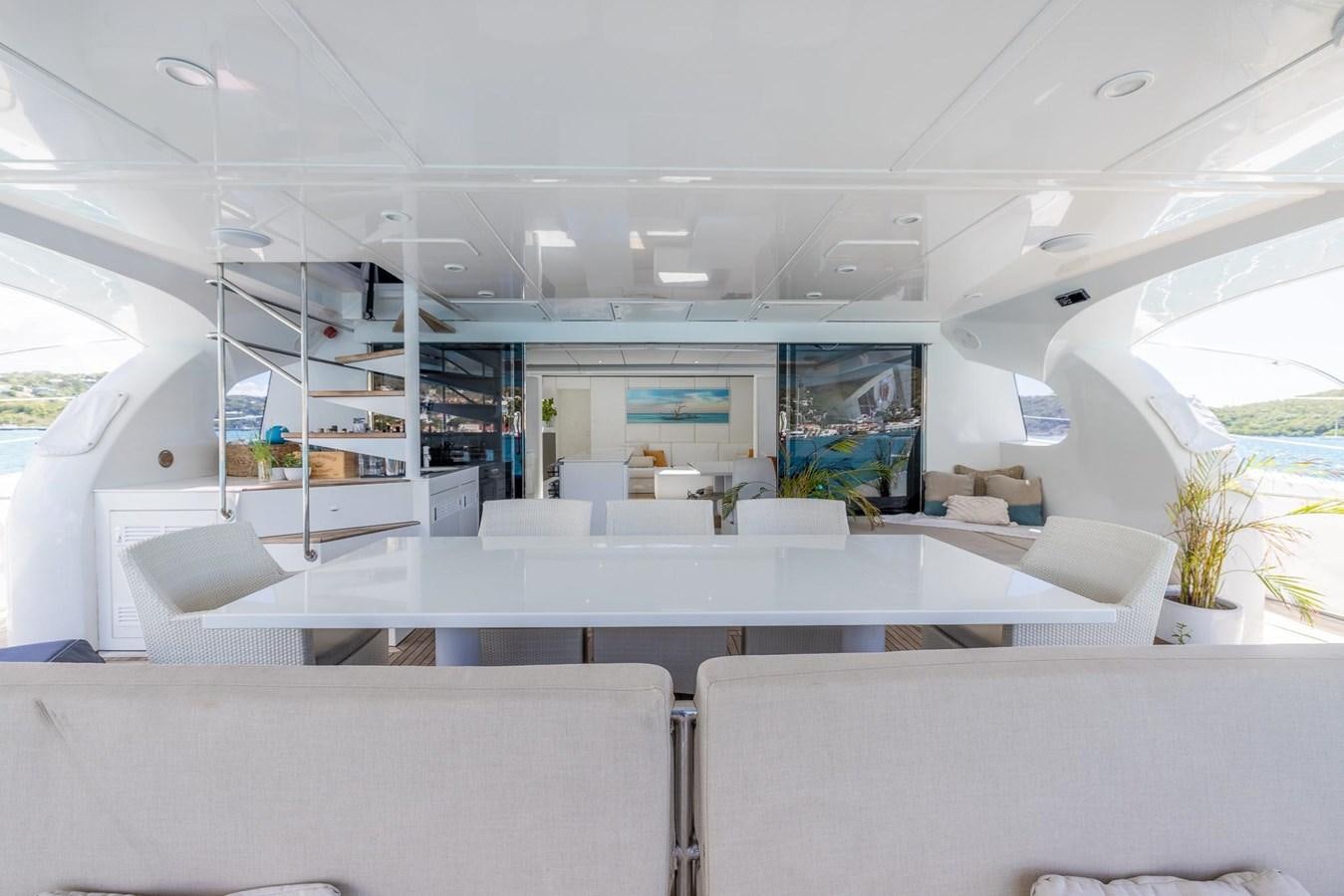 a room with white couches and a bookshelf aboard VALHALLA Yacht for Sale