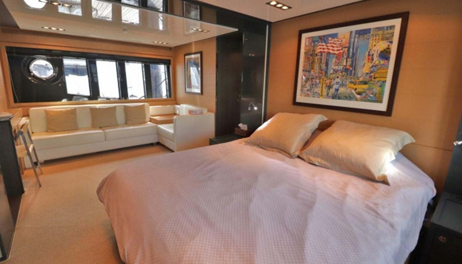 a bed with a couch and a tv on the wall aboard SILVER BREEZE Yacht for Sale
