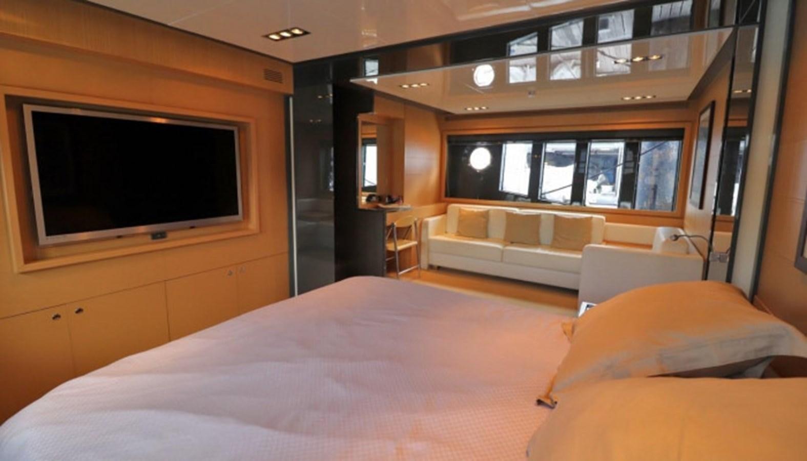 a room with a bed and a tv on the wall aboard SILVER BREEZE Yacht for Sale