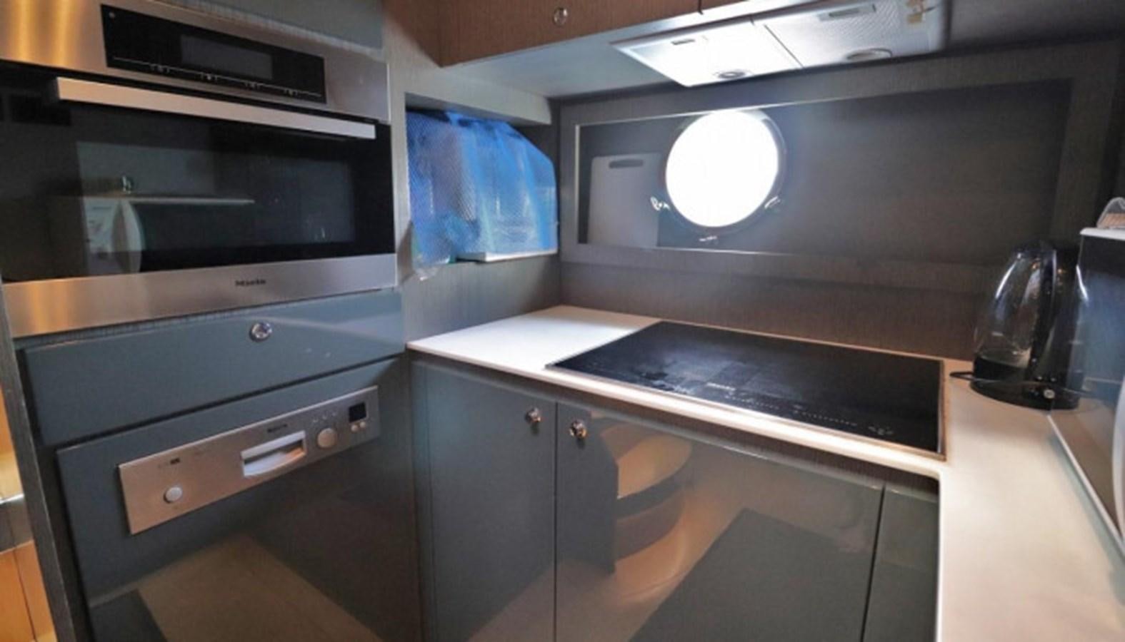 a kitchen with a microwave oven and a stove aboard SILVER BREEZE Yacht for Sale