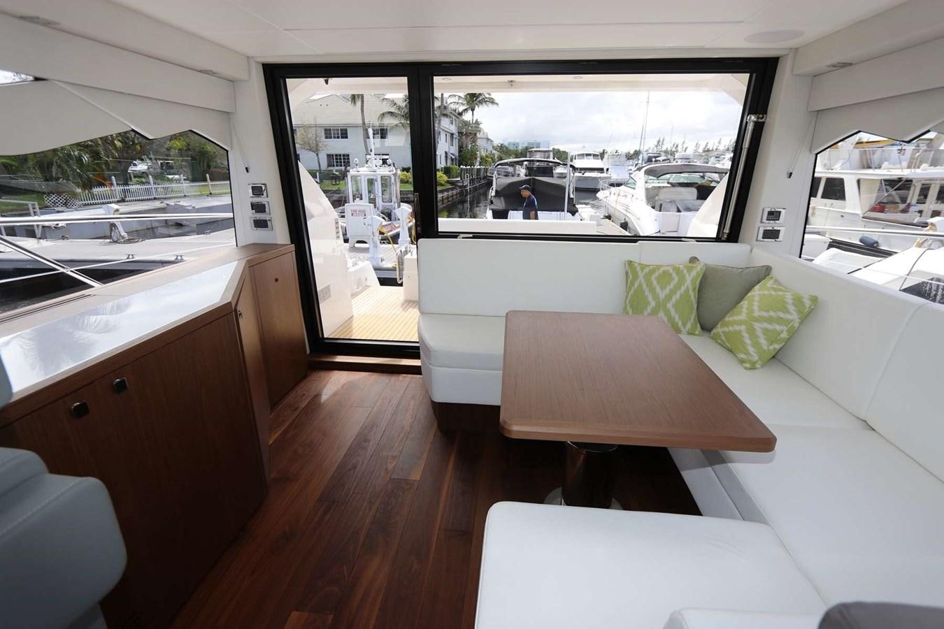 a room with a table and chairs aboard LYDIA SWAG Yacht for Sale