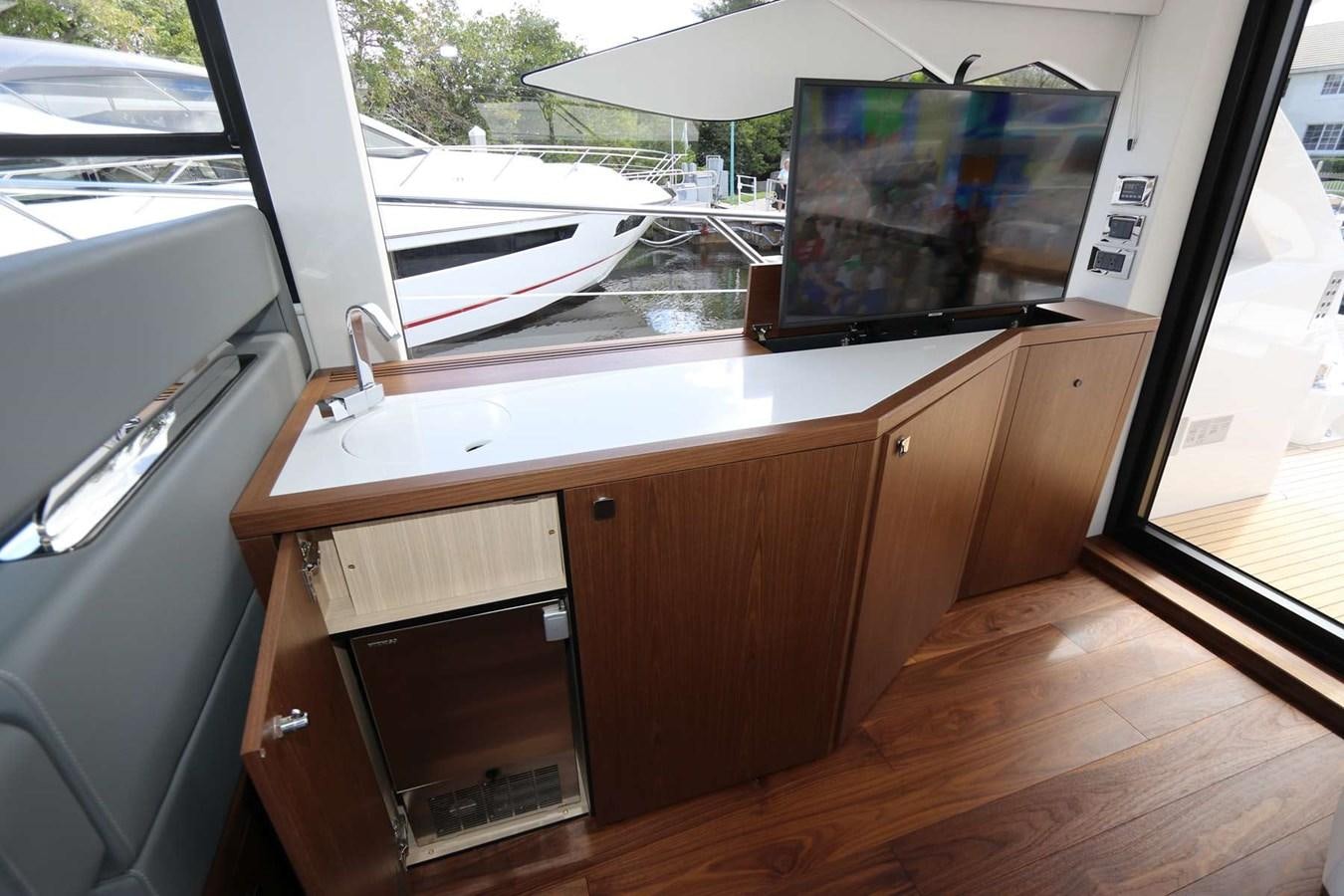 a kitchen with a tv on the wall aboard LYDIA SWAG Yacht for Sale