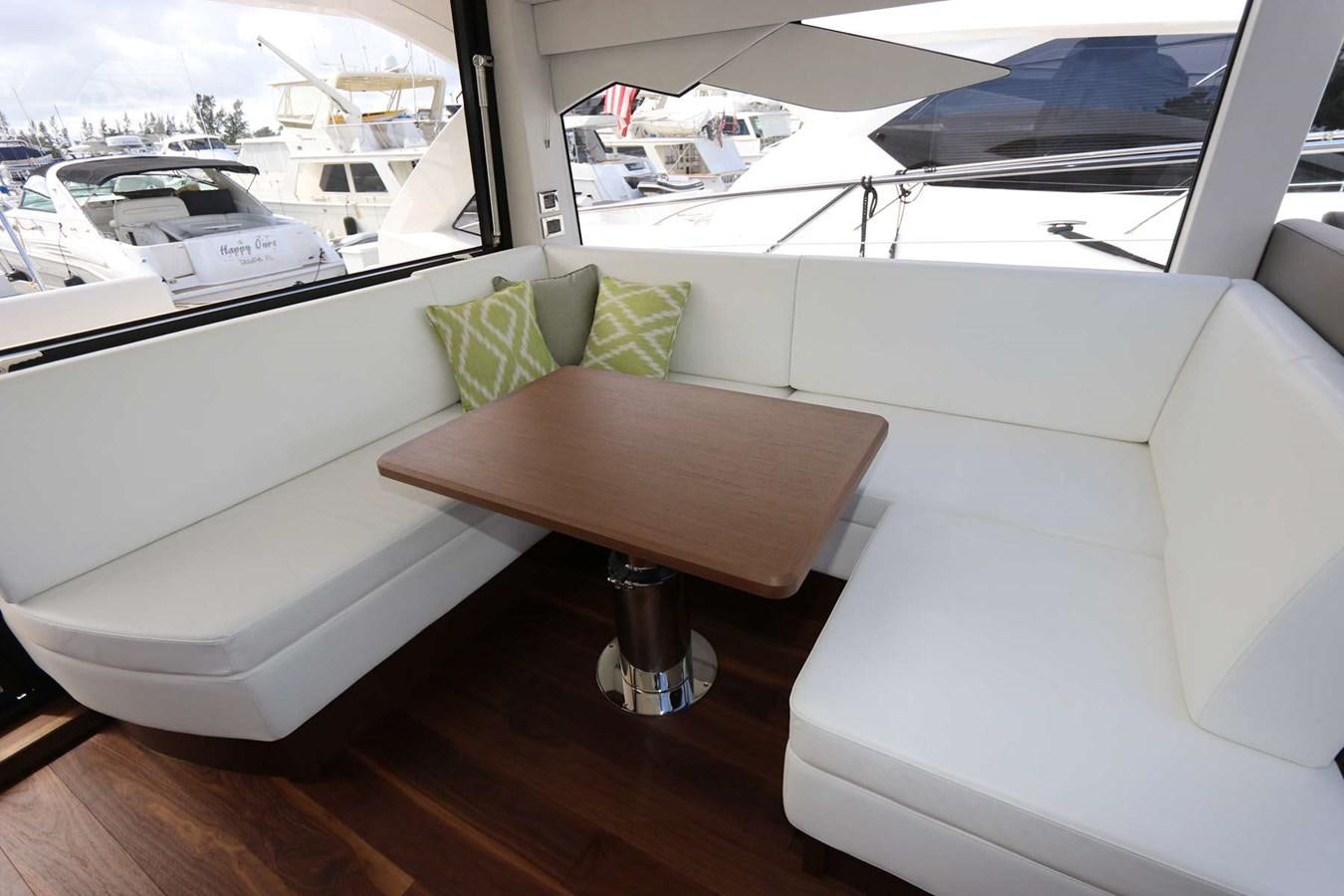 a couch and a table in a room with a window aboard LYDIA SWAG Yacht for Sale