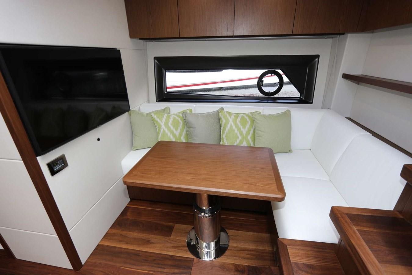a couch with a table in front of it aboard LYDIA SWAG Yacht for Sale