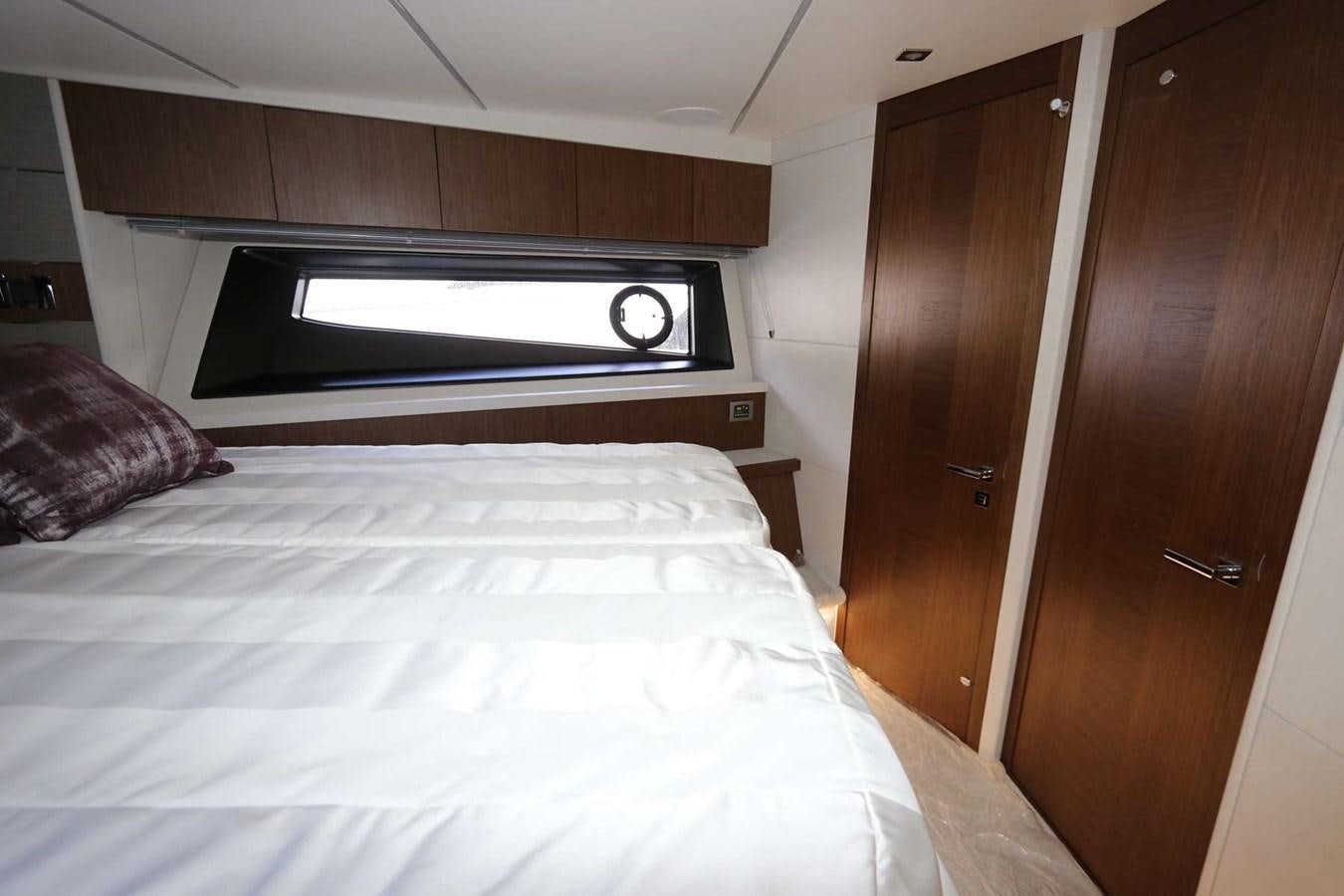 a bed with a television on the wall aboard LYDIA SWAG Yacht for Sale