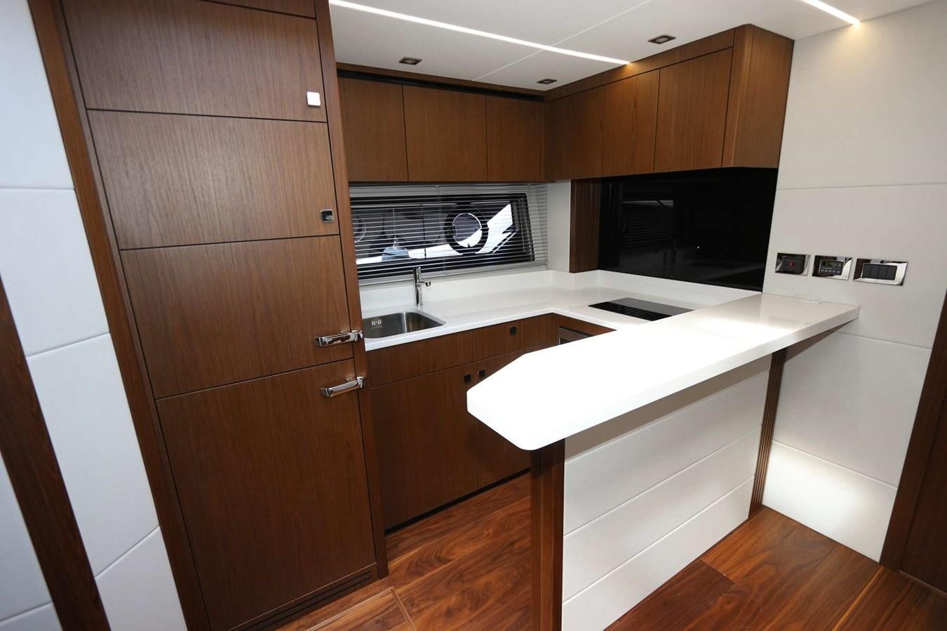 a kitchen with wooden cabinets aboard LYDIA SWAG Yacht for Sale