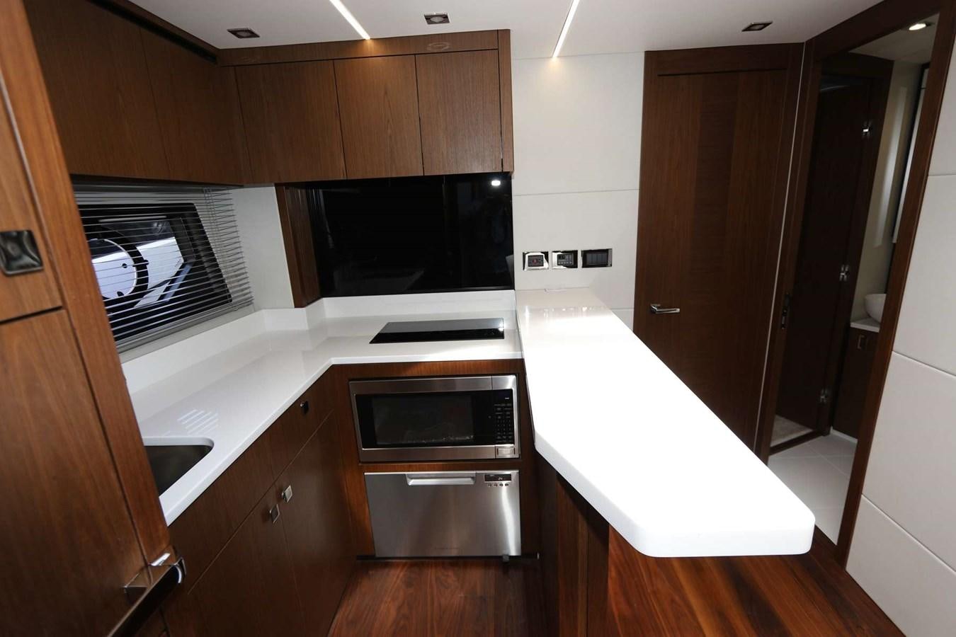 a kitchen with wooden cabinets aboard LYDIA SWAG Yacht for Sale