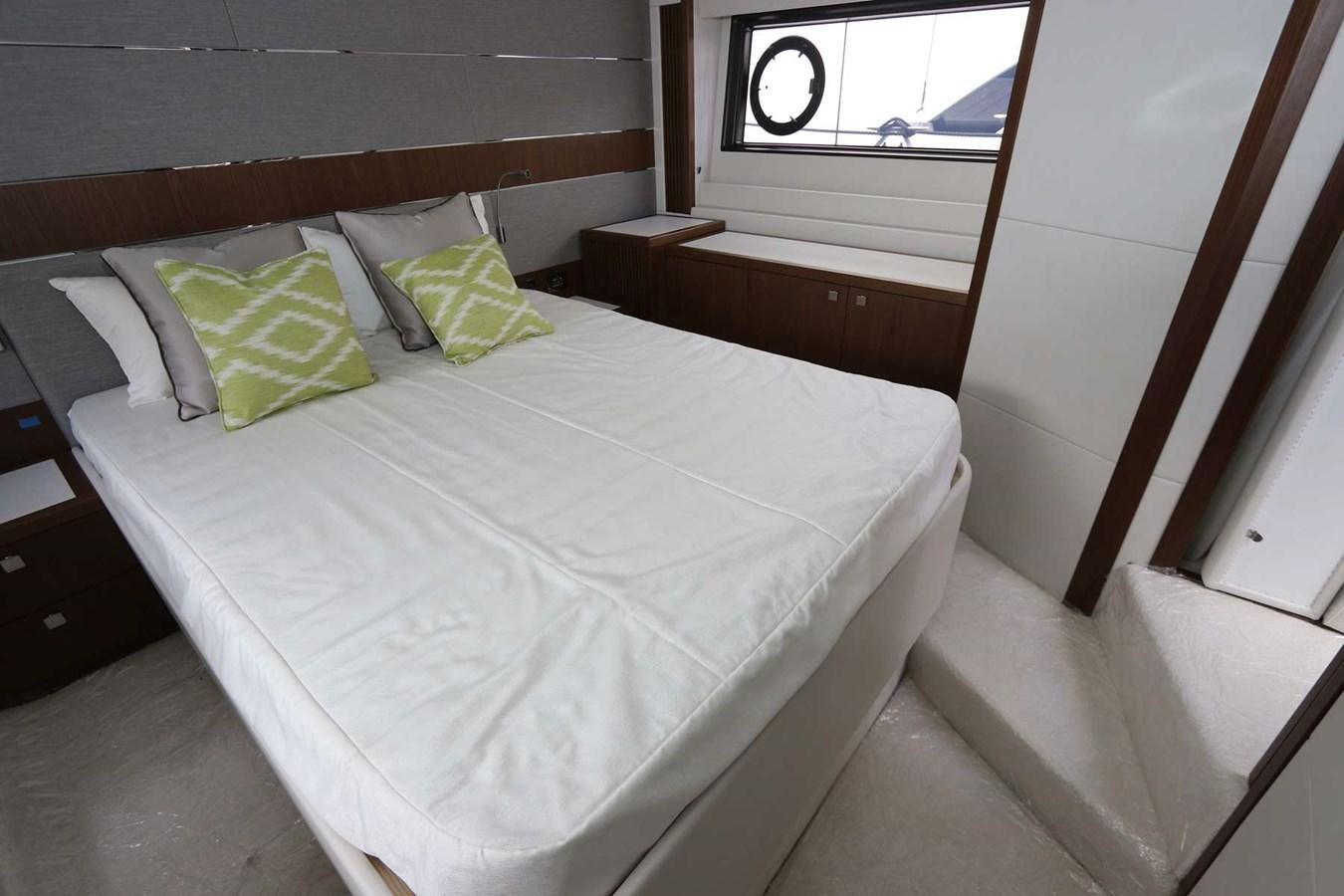 a bed with green and white pillows aboard LYDIA SWAG Yacht for Sale