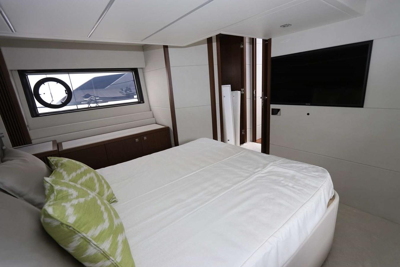 a bed with a television on the wall aboard LYDIA SWAG Yacht for Sale