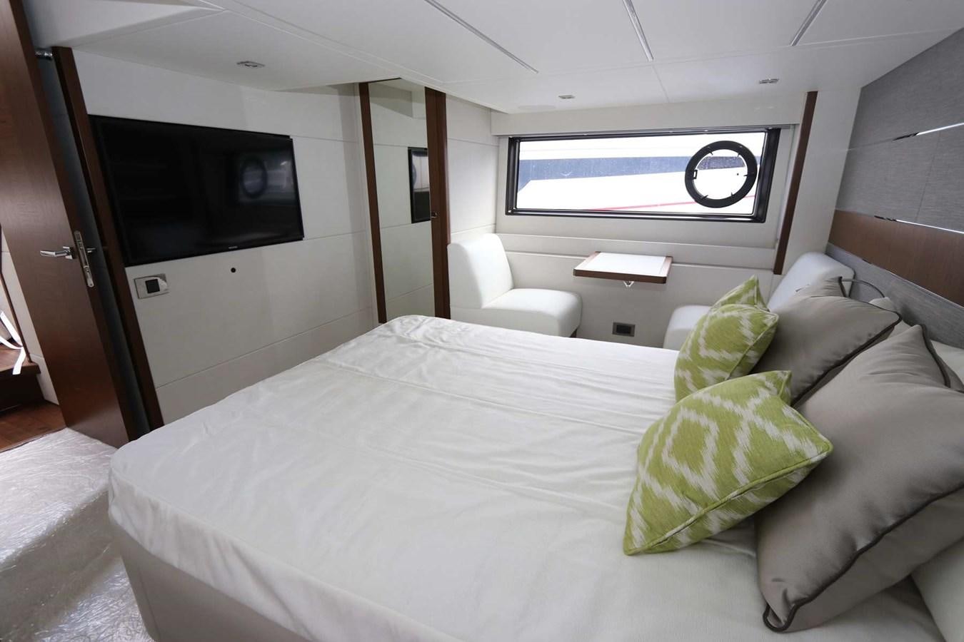 a bed with pillows and a television aboard LYDIA SWAG Yacht for Sale