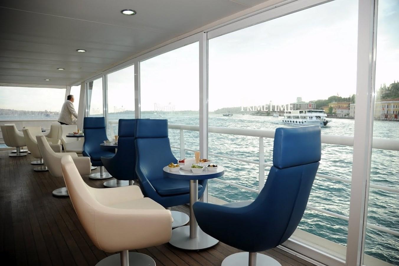 a room with a table and chairs aboard 2011 CUSTOM PASSENGER CRUISE SHIP Yacht for Sale
