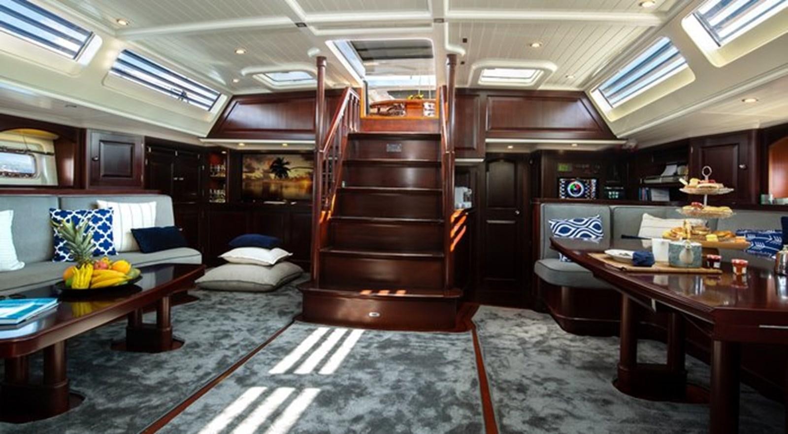 a room with a bed and desk aboard SAVARONA Yacht for Sale
