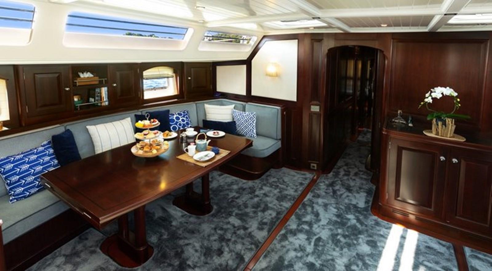 a room with a table and couches aboard SAVARONA Yacht for Sale
