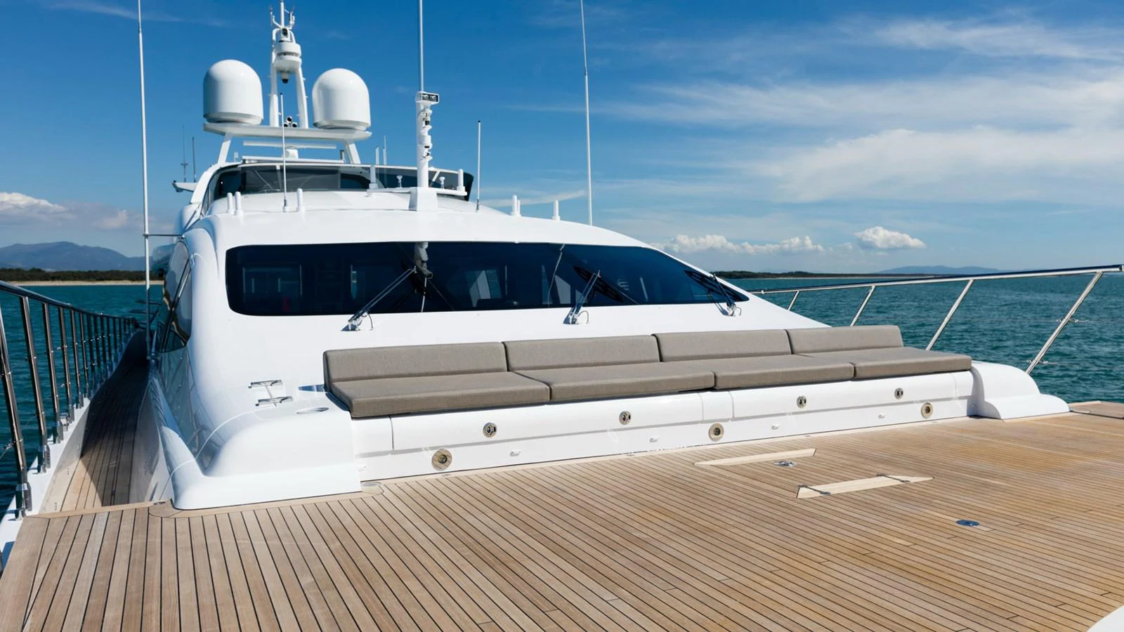 a white yacht on a deck aboard MANGUSTA Yacht for Sale