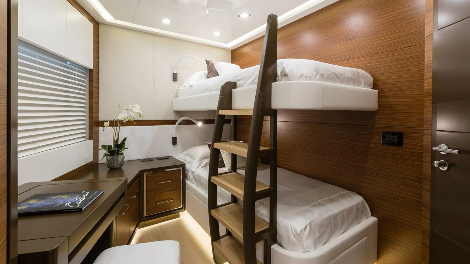 a bed with a desk and a desk aboard MANGUSTA Yacht for Sale