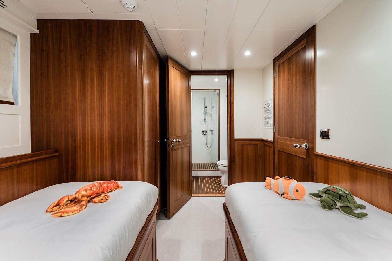 a room with a table and a bed aboard ARCHIPELAGO Yacht for Sale
