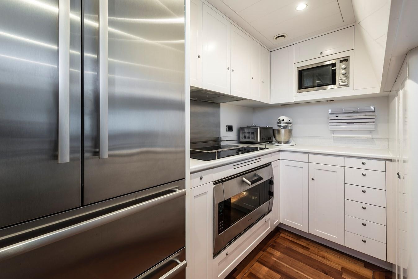 a kitchen with white cabinets aboard ARCHIPELAGO Yacht for Sale