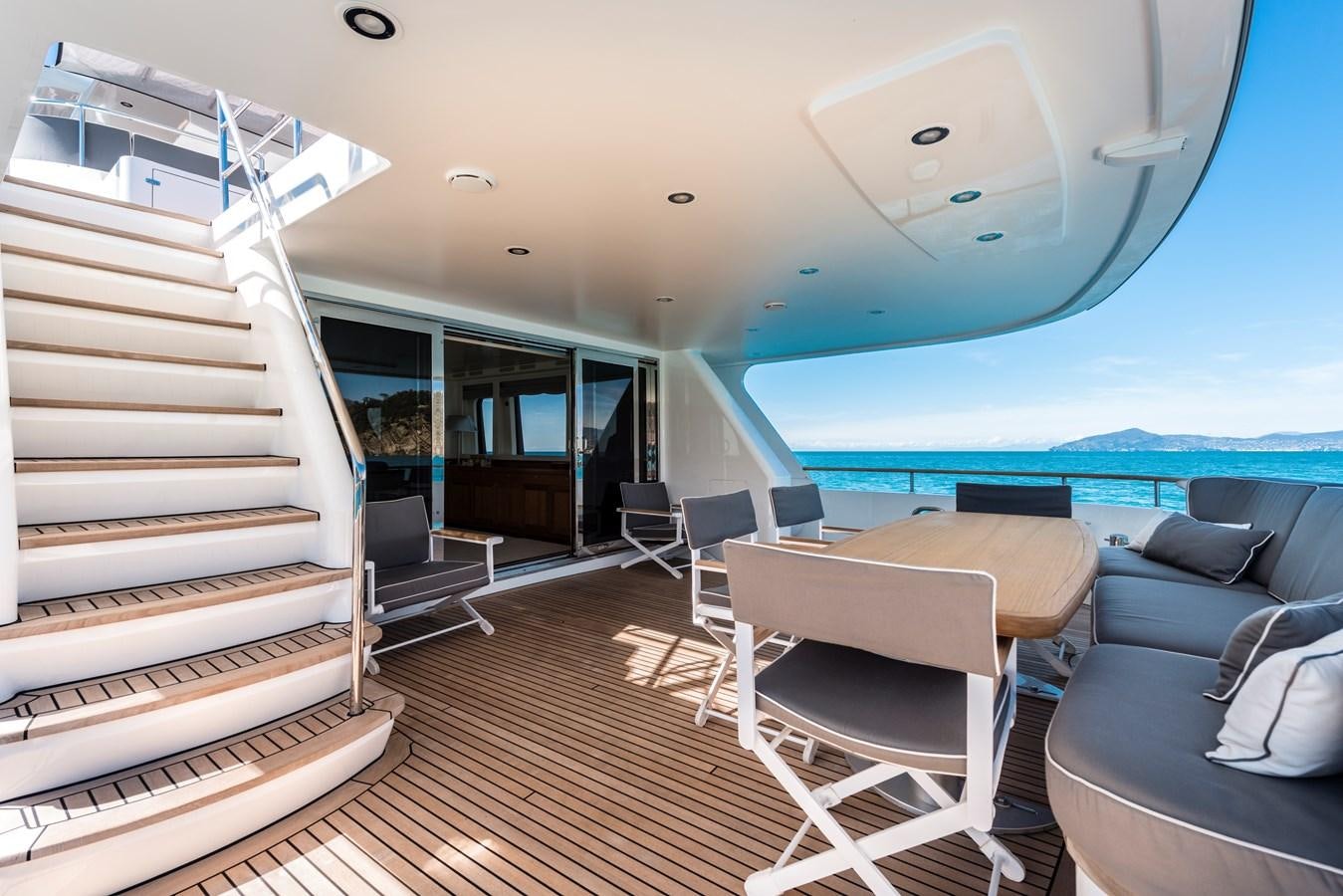 a room with a large bed and a table and chairs aboard ARCHIPELAGO Yacht for Sale