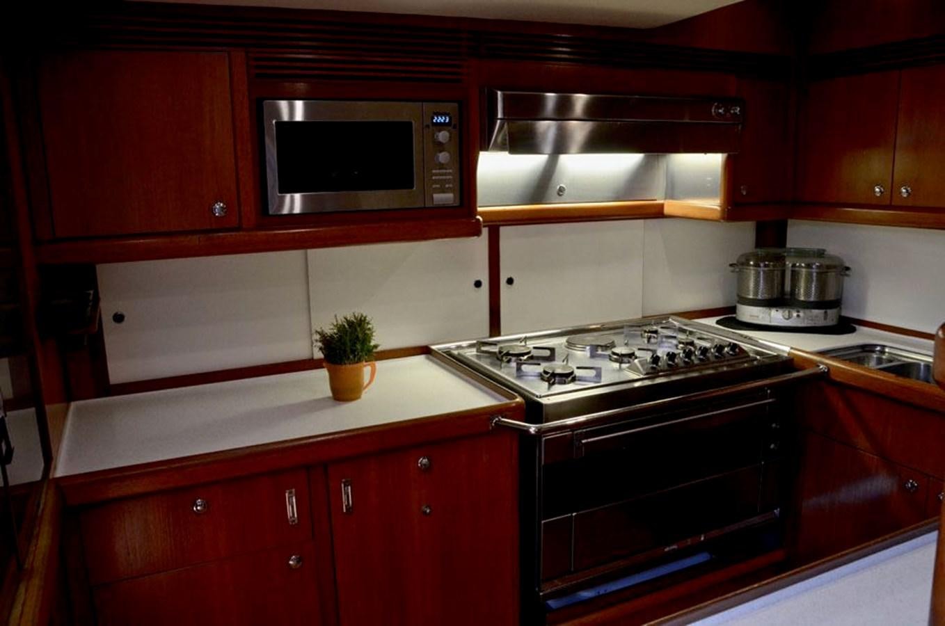 a kitchen with red cabinets aboard STARFALL Yacht for Sale
